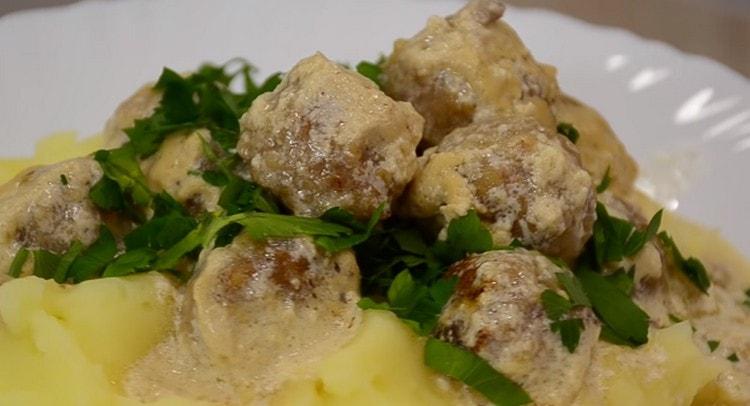 meatballs in a creamy sauce perfectly complement the mashed potato garnish.