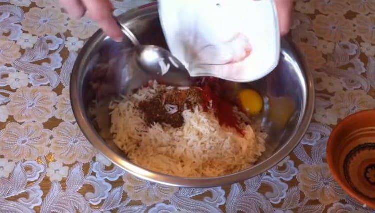 Add spices, egg to the meat with rice.