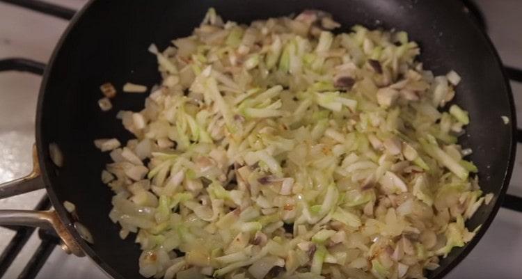 Add crushed champignons to the pan.