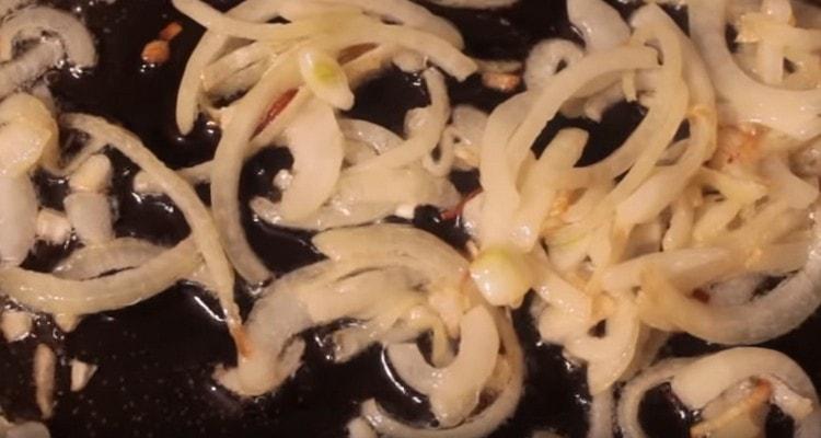 Fry chopped onions in a pan.