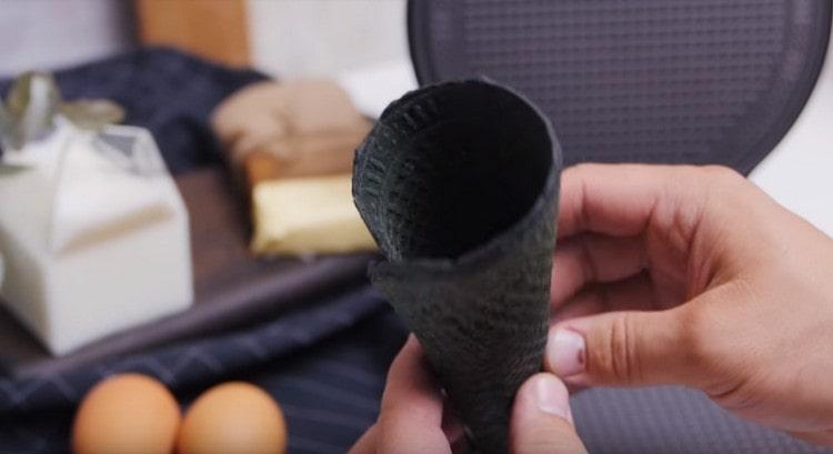 Twist the hot wafer with a cone.