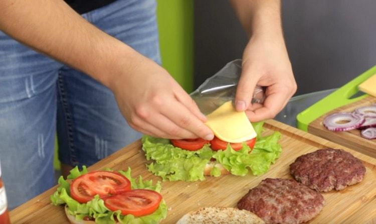 Put a slice of cheese on the tomatoes.