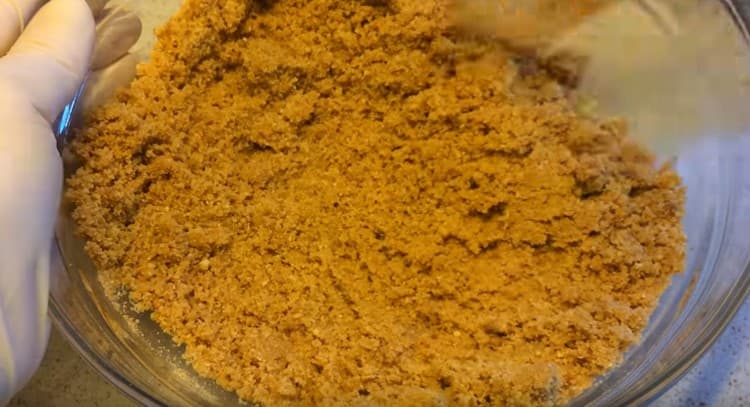 Mix the cookie crumbs with butter.