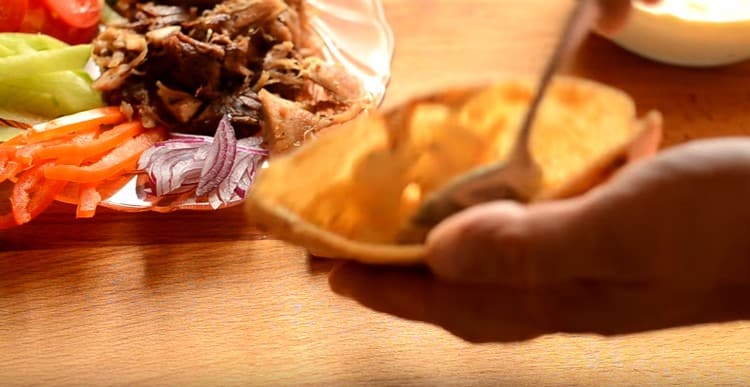 Inside, grease the pita with the sauce.