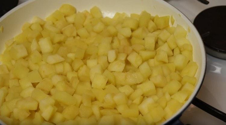 Fry the apples until the moisture evaporates.