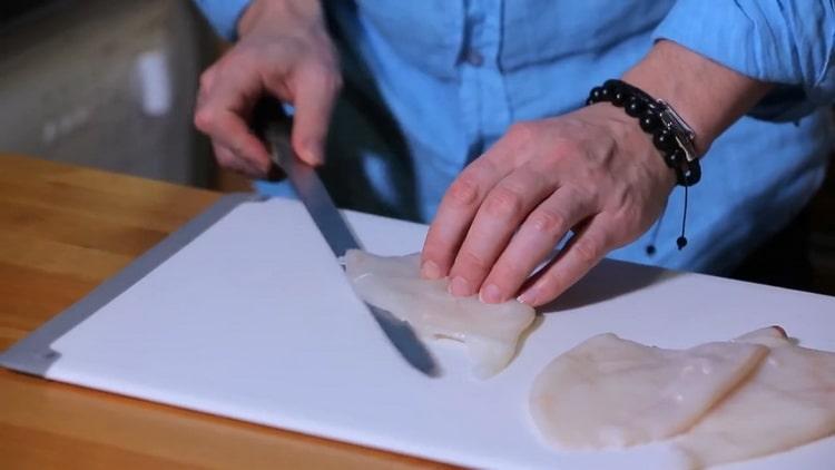 Cooking fried squids with onions