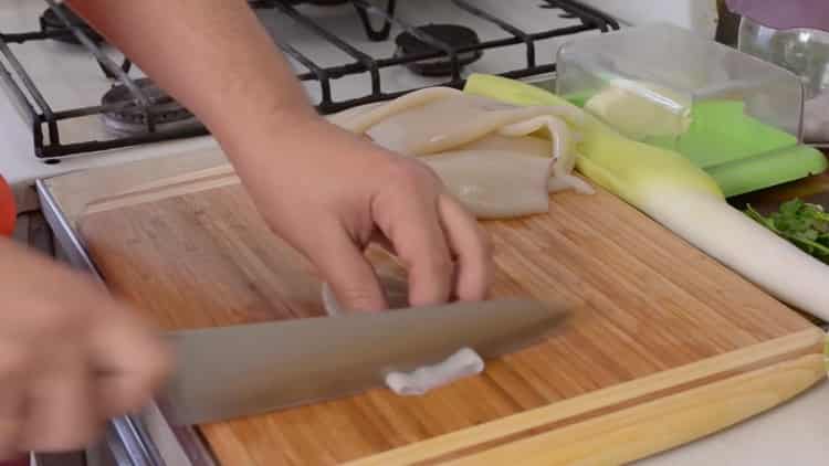 Cooking squid stewed in sour cream with onions