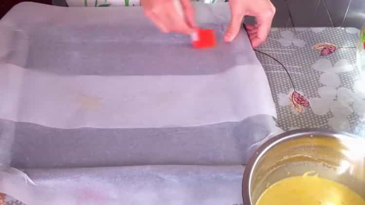 Grease the parchment to prepare the meal.