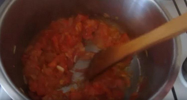 Add the sliced tomato to the onion.