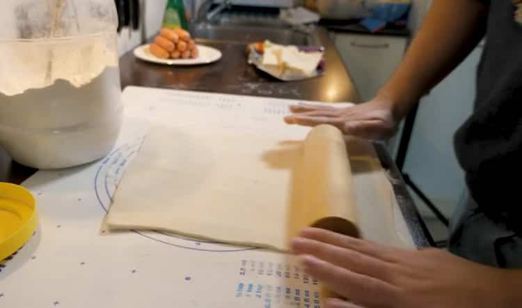 Roll out the dough to make sausages