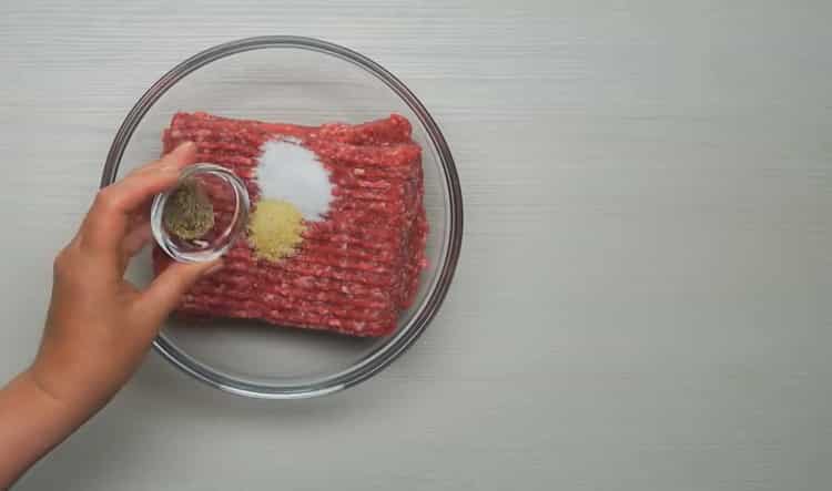 Cooking meatballs in tomato sauce in a pan