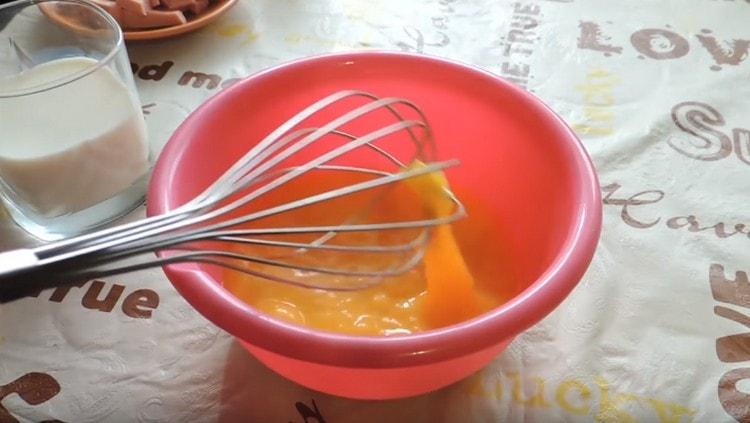 Beat eggs lightly with a whisk.