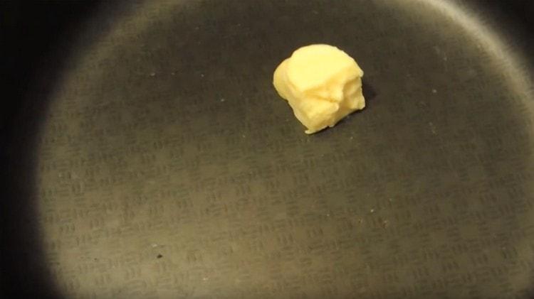 We heat the pan, put a piece of butter on it.