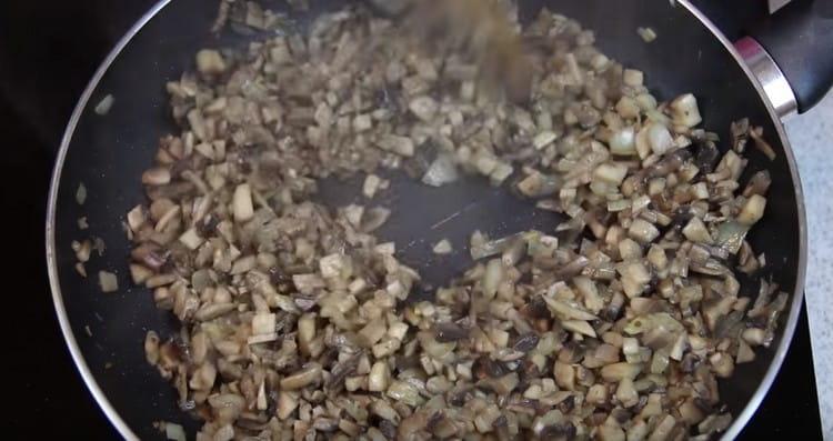 Add carrots and mushrooms to the onion.