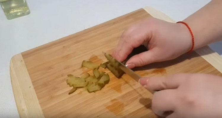 Cut pickles into strips.
