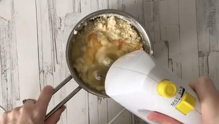 Whip the ingredients to make the pudding.