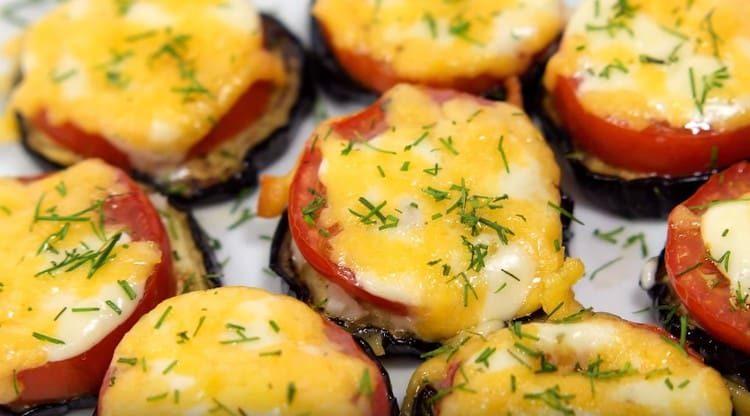 Ready eggplant with tomatoes and cheese can be sprinkled with chopped dill.