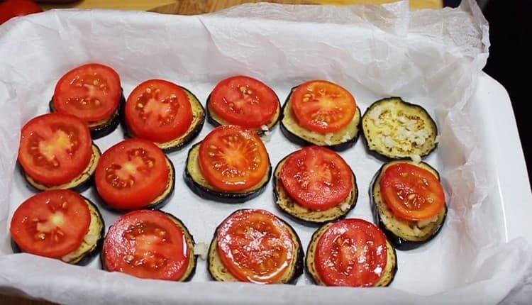 On top of each with eggplant slices, spread a circle of tomato.