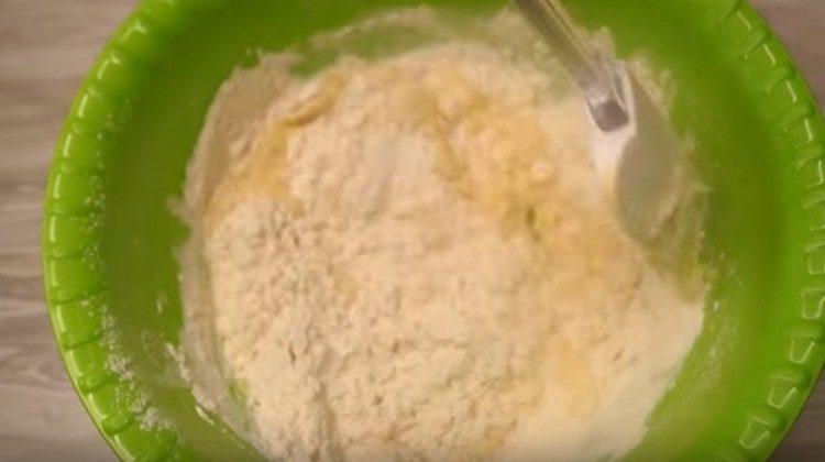 Add flour to the liquid ingredients and mix.