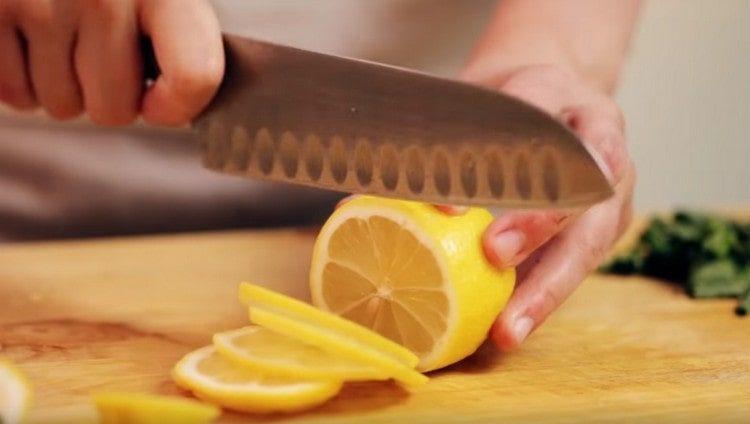 Cut lemon into thin slices.