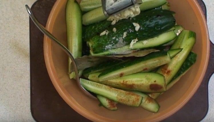 Add chopped garlic to the cucumbers.