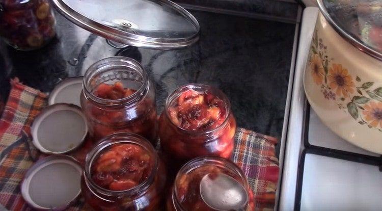 After sterilization, the plums must be transferred from one can to another, because they are hooked.