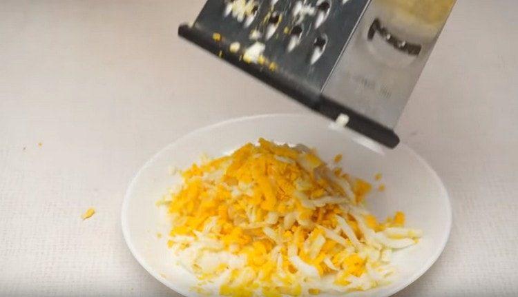 Grate boiled eggs.