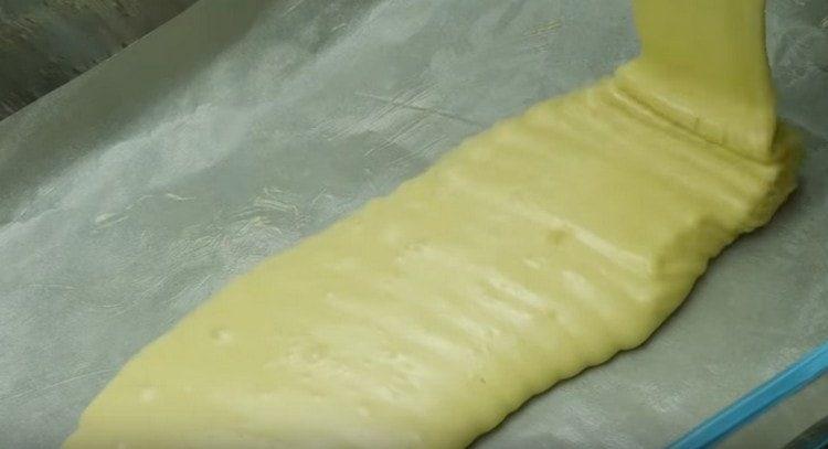 Pour half the dough into the mold and put in the oven.