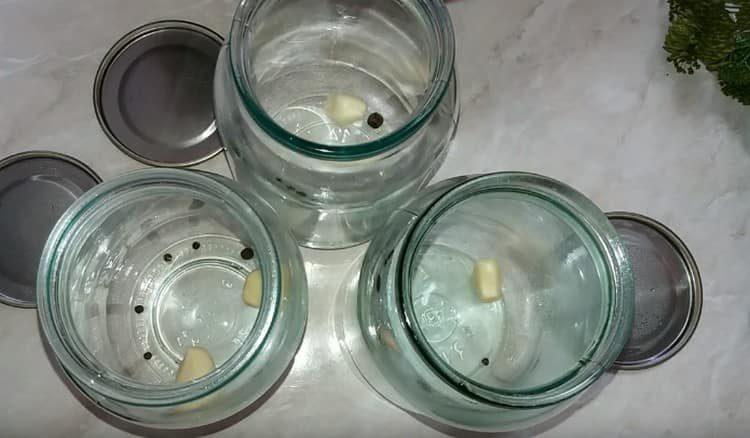 In each jar we put peppercorns and garlic.