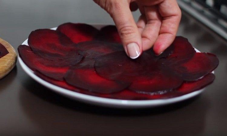 Beautifully lay the beet slices on a serving dish.