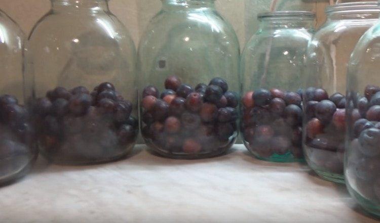 Put plums in sterilized jars.