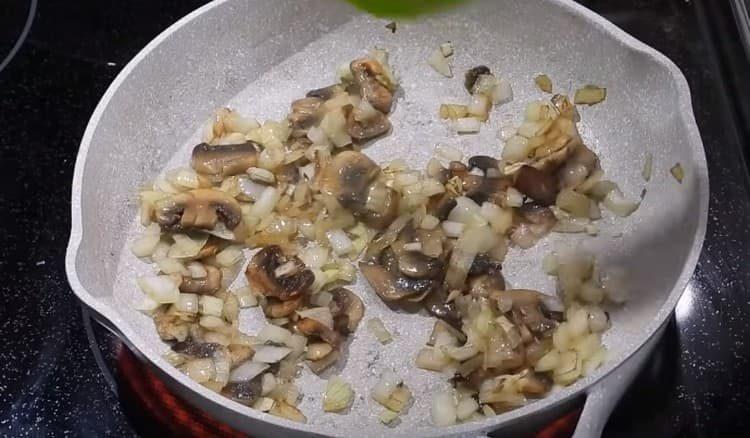 Add chopped onions to the mushrooms, fry.