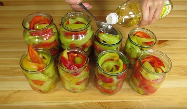 Add vegetable oil and vinegar to each jar.