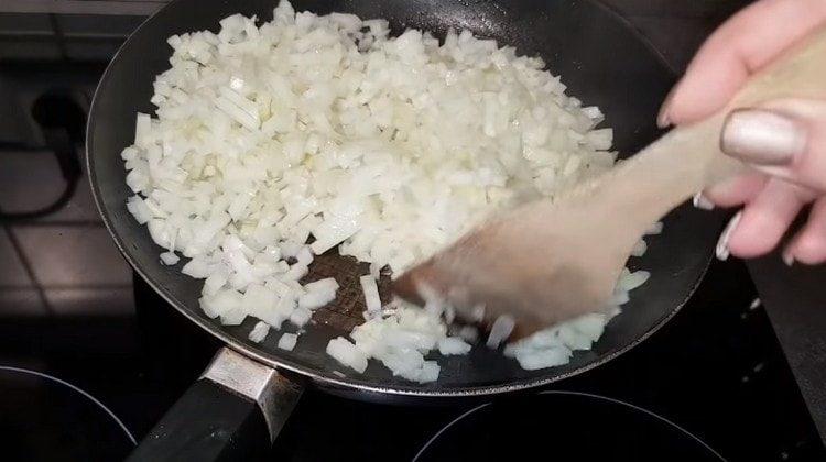 Fry chopped onions in a pan.