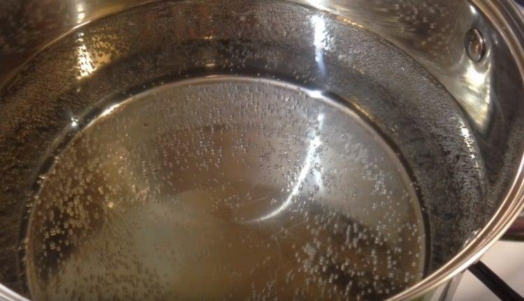 In a saucepan, boil water.