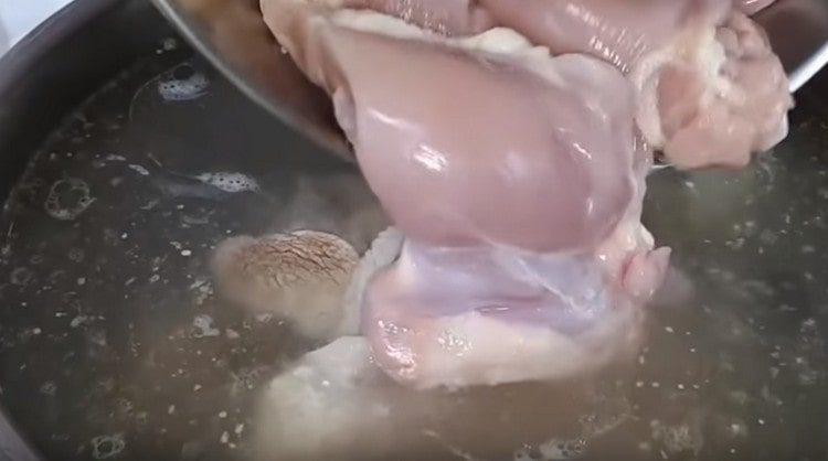 Add chicken thighs to boiling broth.