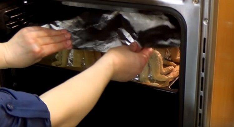 Put the baking sheet in the oven, cover the octopuses with foil on top.