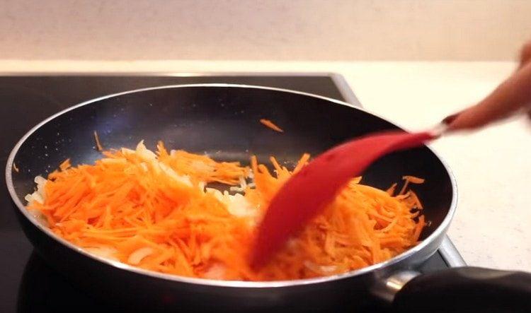 Add the grated carrots to the onion.
