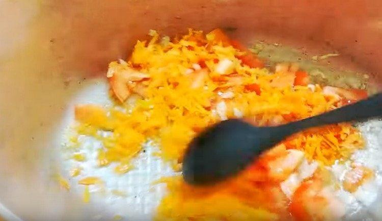 Add carrot and tomato to the onion.