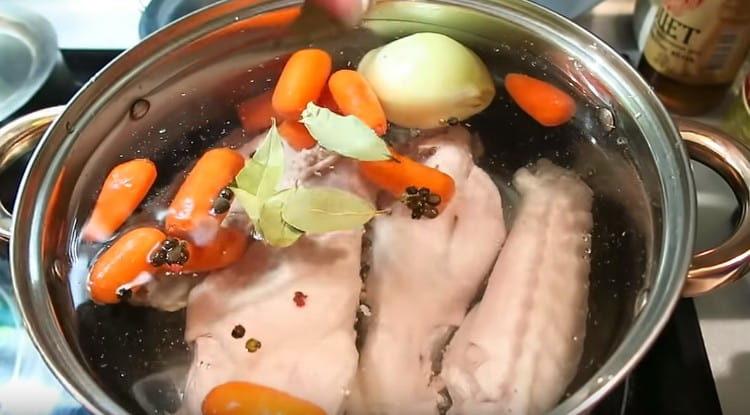 after boiling, change the water, add carrot, onion, bay leaf, peppercorns to the pan.