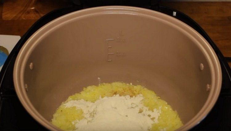 Add spices and flour to the onion.