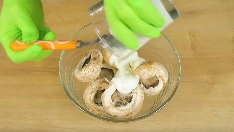 Mushrooms hats marinate in yogurt and spices.