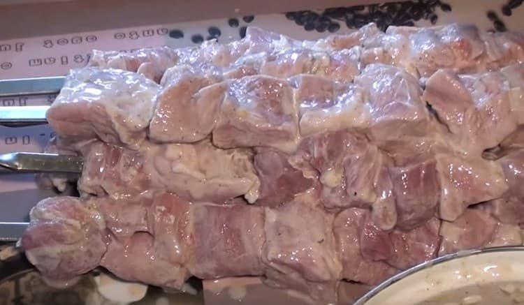 string meat on skewers.