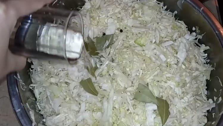 Add bay leaf, peppercorns, vinegar to the cabbage.