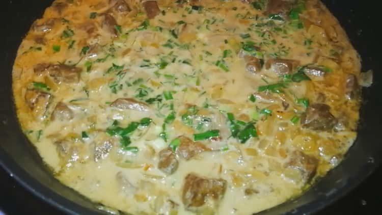 liver in sour cream with onions in a pan is ready