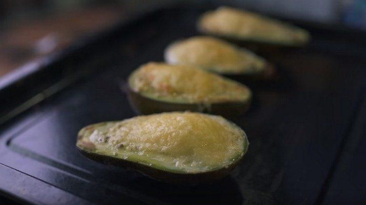 Bake an avocado under the grill for several minutes.