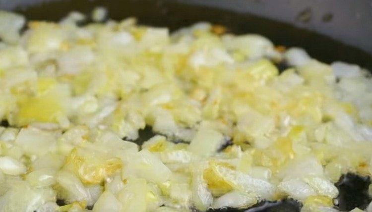 Fry chopped onions in a pan.