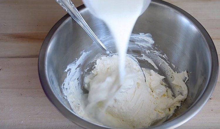 Add warm milk to the curd mass.
