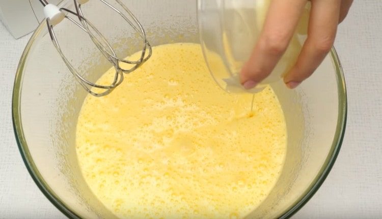 Add melted butter to the egg mass.