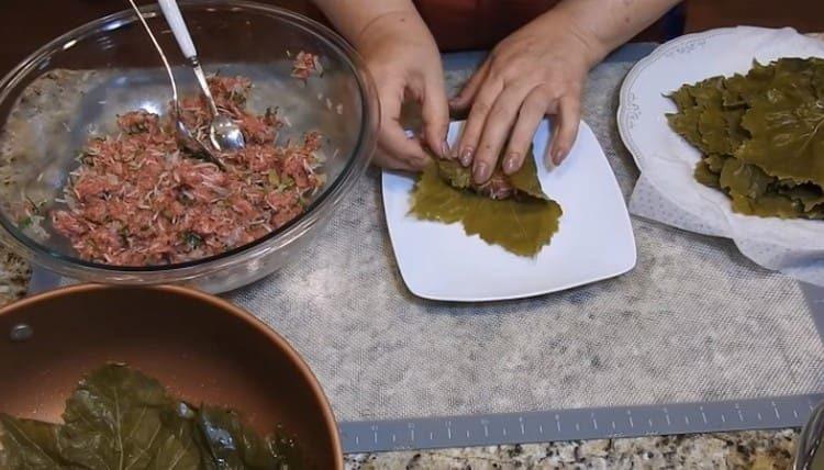 We spread the filling on the sheet, twist the dolma